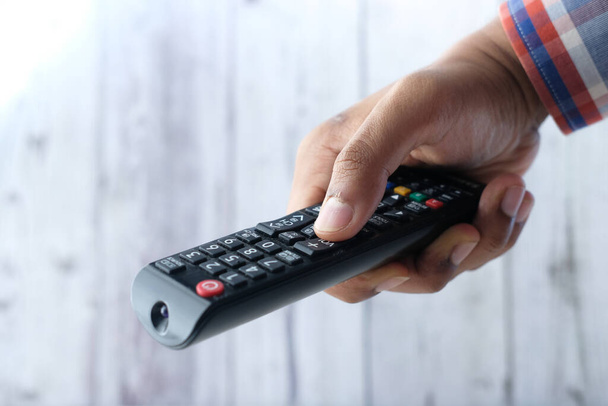 close up of man hand holding tv remote. - Photo, Image
