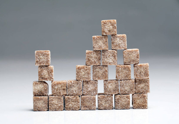 Brown raffinate sugar over the grey background - Fotografie, Obrázek