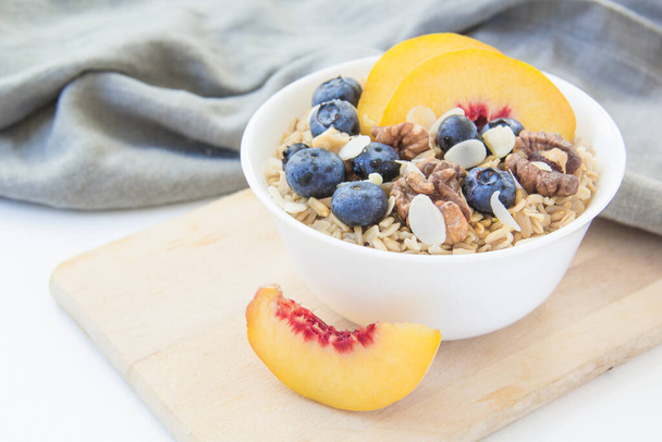 Oatmeal porridge with blueberries. Superfood for healthy nutritious breakfast - Фото, зображення