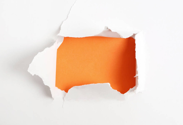Concept. Torn paper with orange background - Фото, зображення