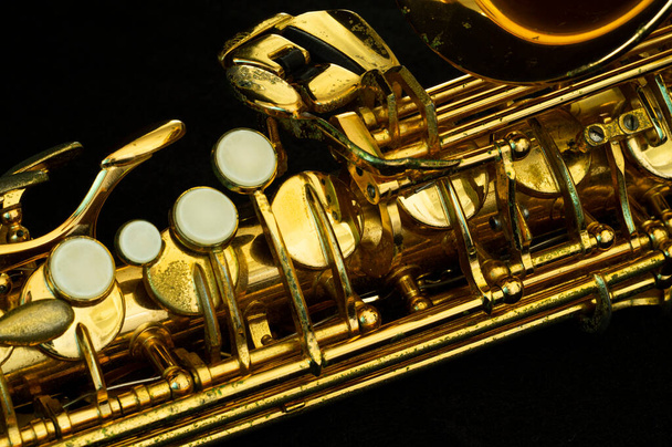 close up on alto saxophone details, black background, short depth of field. - Фото, зображення
