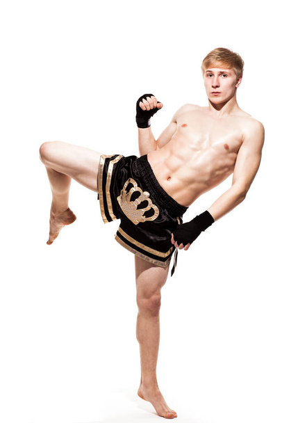 Young handsome fighter in shorts isolated over white baqckground - Photo, Image