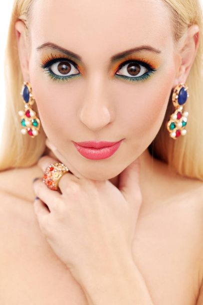 Blonde girl with jewelry has colored makeup - Foto, Imagen