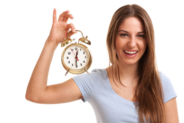 Young caucasian woman with alarm clock in her hands - Photo, Image