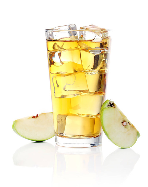 A glass of refreshing apple juice with lots of ice inside and an green apple near the glass - Zdjęcie, obraz