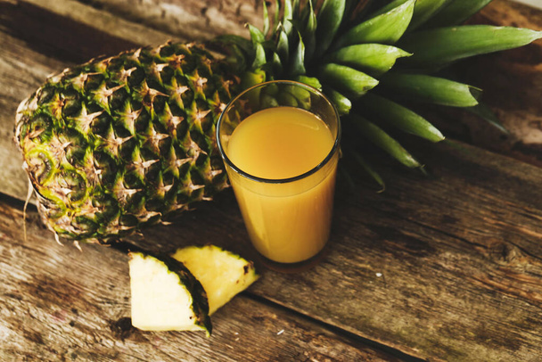Pineapple on a wooden table - Photo, Image