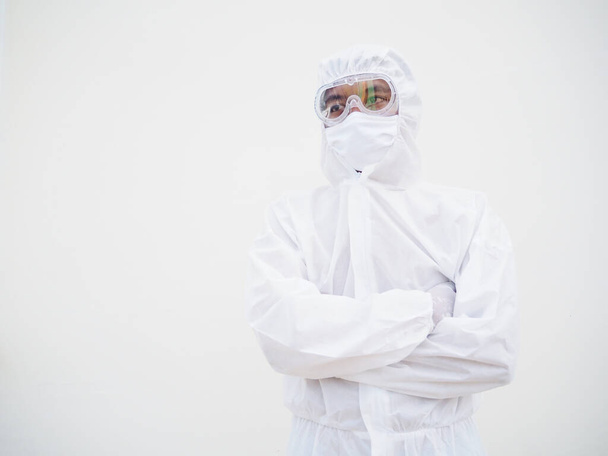 Portrait of confident asian male doctor or scientist in PPE suite uniform while folding his hands in the white background. coronavirus or COVID-19 concept. - Valokuva, kuva