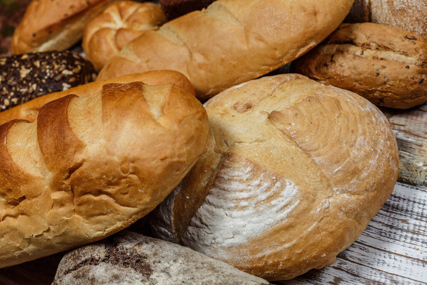 Fresh gluten free bread on a wooden surface in provence style - Foto, imagen