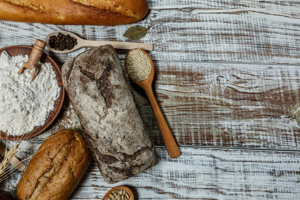 Fresh gluten free bread on a wooden surface in provence style - 写真・画像
