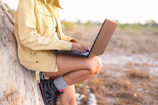 Solo traveller asian woman tourist using internet with laptop computer at forest,Travel and vacation concept - 写真・画像