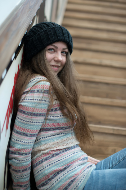 όμορφη κοπέλα καθόταν στα ξύλινα σκαλοπάτια - Φωτογραφία, εικόνα