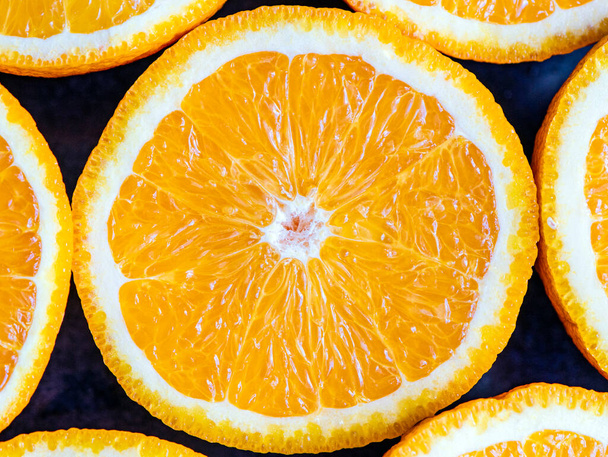 oranges or grapefruits are cut in half on a black background. close up macro - Photo, Image