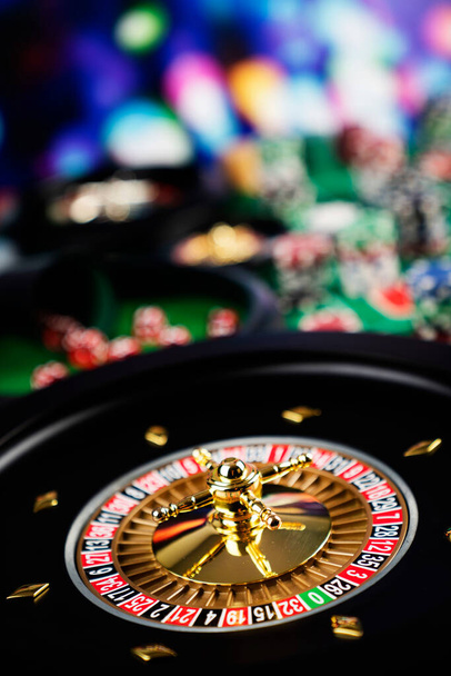 Casino theme, close up of roulette, red and black numbers. Stack of chips in the background. - Photo, Image