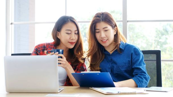 Two young asian women working with laptop computer at home office with happy emotion, Asia girls learning online education, working from home, small business, office casual lifestyle concept - Foto, imagen