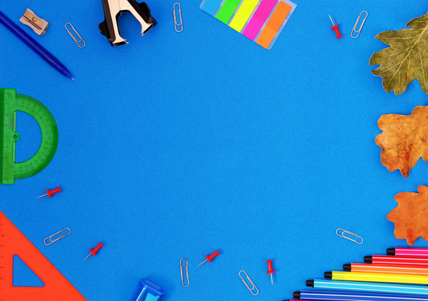 Flatlay banner copy space back to school for stationery stores. for schools, offices, rulers, pens, markers, paper clips laid out in a circle on a blue background top view - Photo, Image