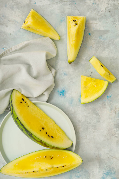 Cut yellow watermelon on table - Foto, immagini