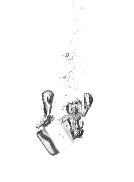 Falling of ice cube into water on white background - Foto, Imagem