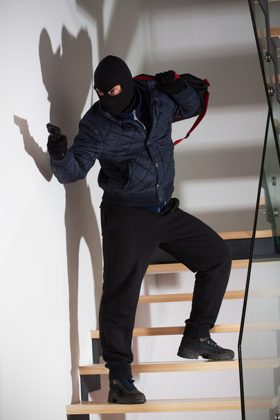 Armed robber on stairs - Φωτογραφία, εικόνα