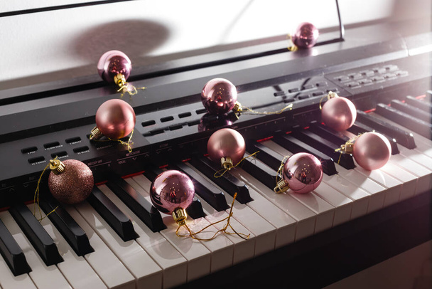 A piano with christmas lights and tree - Photo, Image