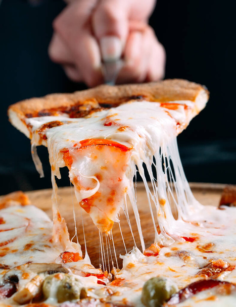 Pizza with very much cheese melting. - 写真・画像
