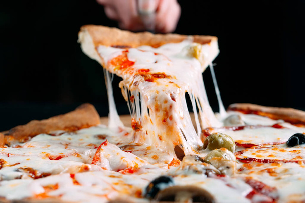 Pizza with very much cheese melting. - Valokuva, kuva