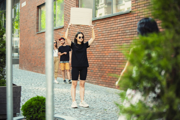 Dude with sign - woman stands protesting things that annoy her - 写真・画像