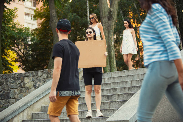 Dude with sign - woman stands protesting things that annoy her - Photo, image