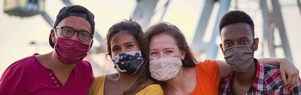 Group of multiracial friends taking photo with face mask on - Photo, Image