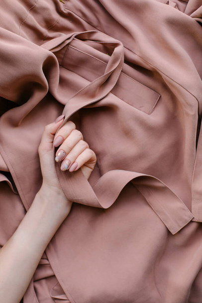 Stylish trendy autumn manicure super look. Beige nude gel polish. Top view place for text. Copy space banner. Pink delicate matte shades. Luxury natural design. fashion 2020 October. warm trench coat - Valokuva, kuva