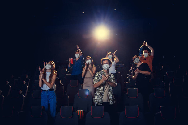 Cinema, movie theatre during quarantine. Coronavirus pandemic safety rules, social distance during movie watching - Foto, Imagen