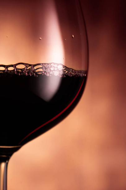 Goblet with red wine on glowing background - Photo, Image
