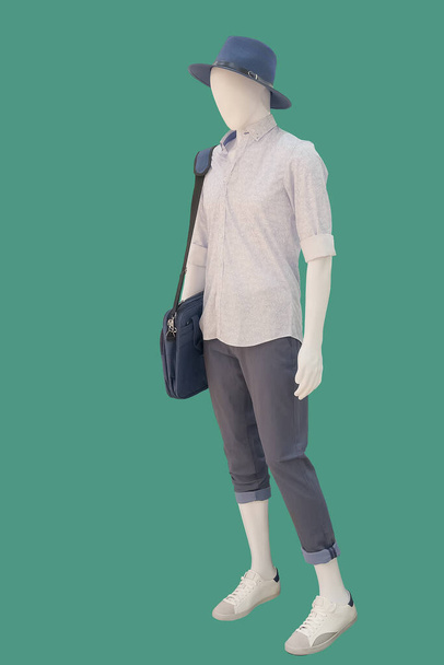 Full length male mannequin dressed in casual clothes, isolated on green background. No brand names or copyright objects. - Photo, Image