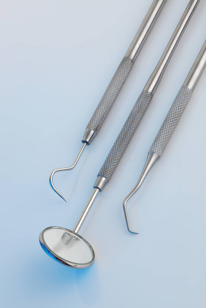 Dental tools in a clinical blue light - Fotoğraf, Görsel