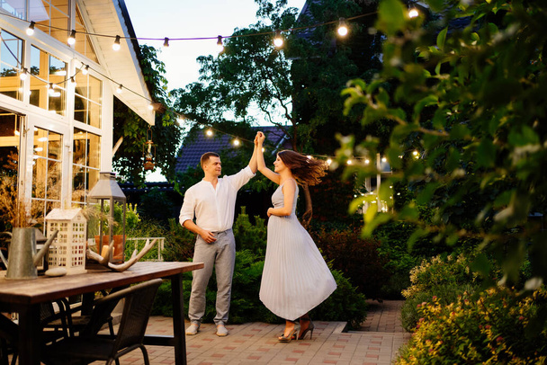 pregnant woman and man is dancing in garden - Photo, image