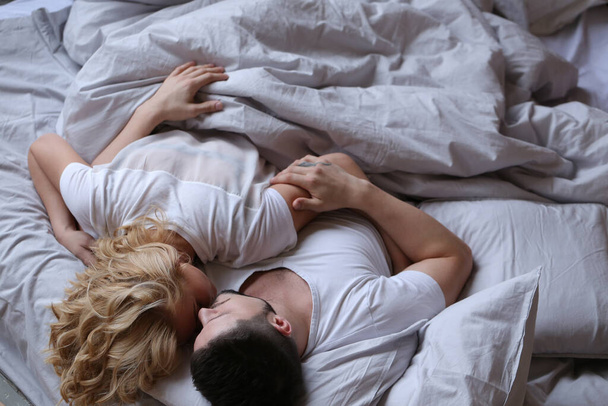 Lifestyle. Beautiful couple in bed - Photo, Image