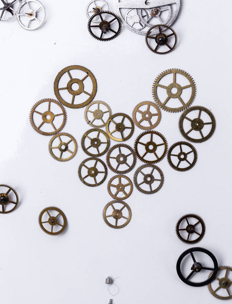 Details, technology. Heap of small gears on a white background - Photo, Image