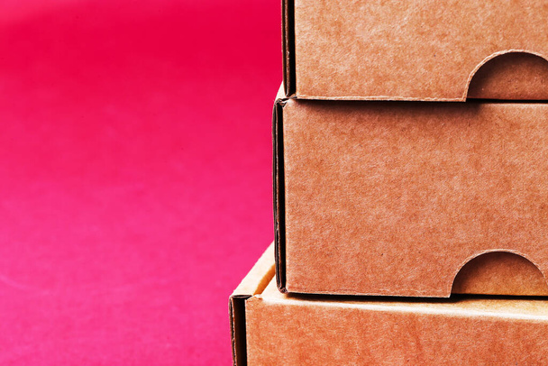 Carton boxes on a pink background - Fotoğraf, Görsel