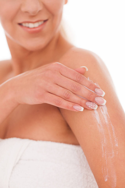 Beautiful woman massage herself with white cream - Фото, изображение