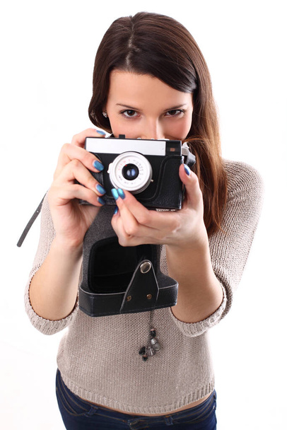 Beautiful girl posing with camera in studio - Foto, afbeelding