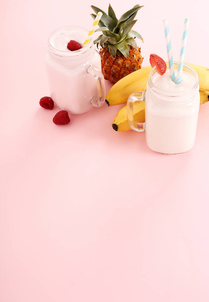 Delicious milkshake on a pink background - Photo, Image