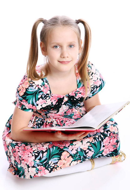 Cute girl with big book over white background - Fotoğraf, Görsel