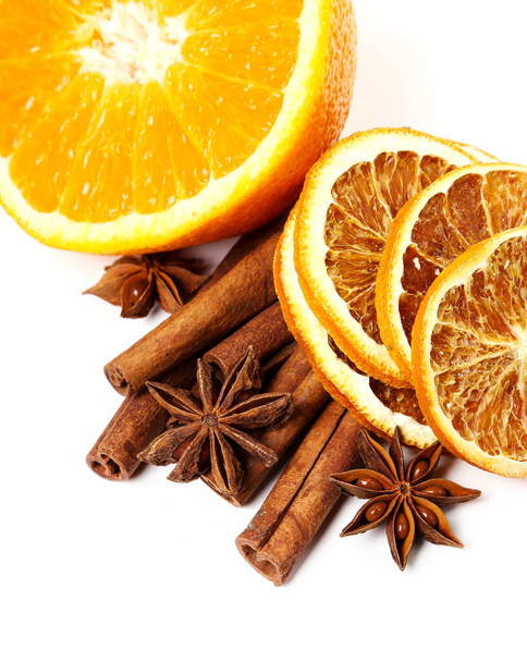 Cinnamon with orange on the table - 写真・画像
