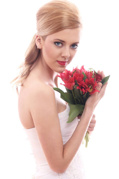 Beautiful bride with red tulips over white background - Fotoğraf, Görsel