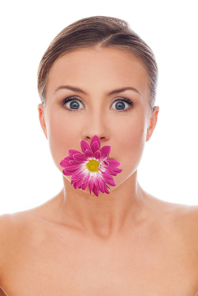 Funny picture of young beautiful woman with flower in mouth - Foto, afbeelding