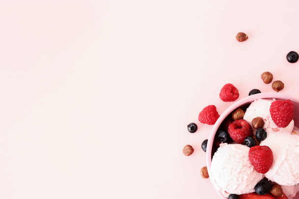 Yummy ice cream with berries, on a pink background - Фото, зображення
