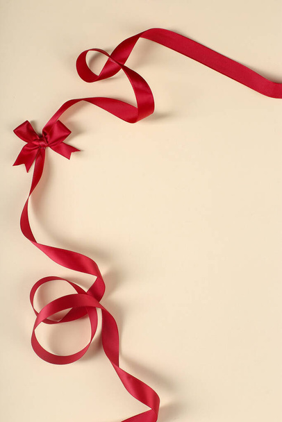 Christmas. Red ribbon on a yellow background - Foto, Imagem