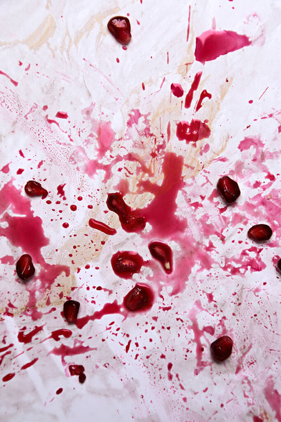 Smashed pomegranate on the table - Photo, Image