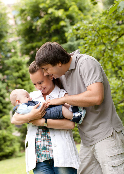 Young and happy family get stroll in the  park - Photo, Image