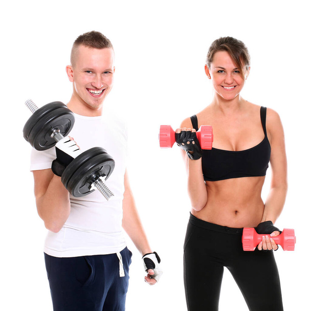 cheerful and sporty couple posing on white background - Fotografie, Obrázek