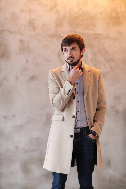 Studio portrait of handsome man in coat - Foto, Bild